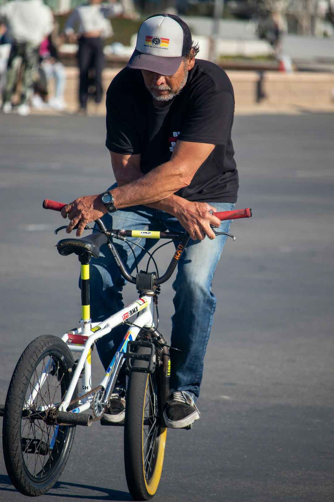A cyclist examining a bike at a road bike clearance sale