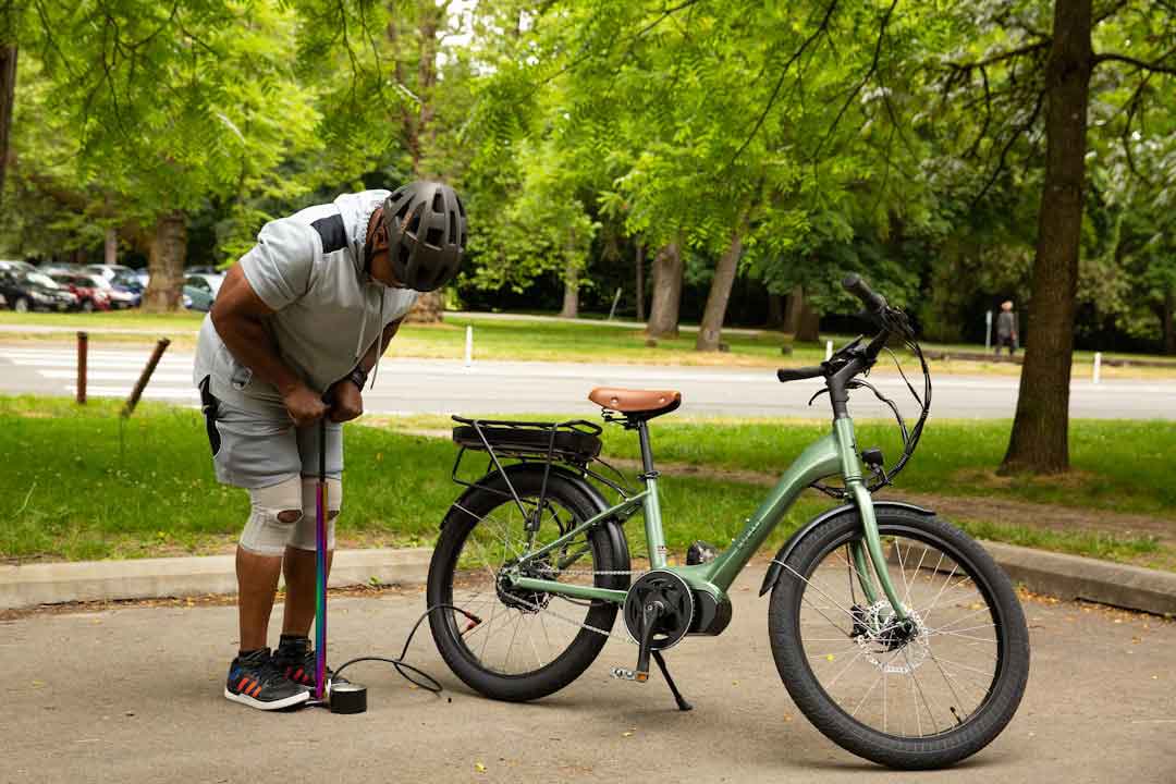 Cyclist adjusting bike saddle height