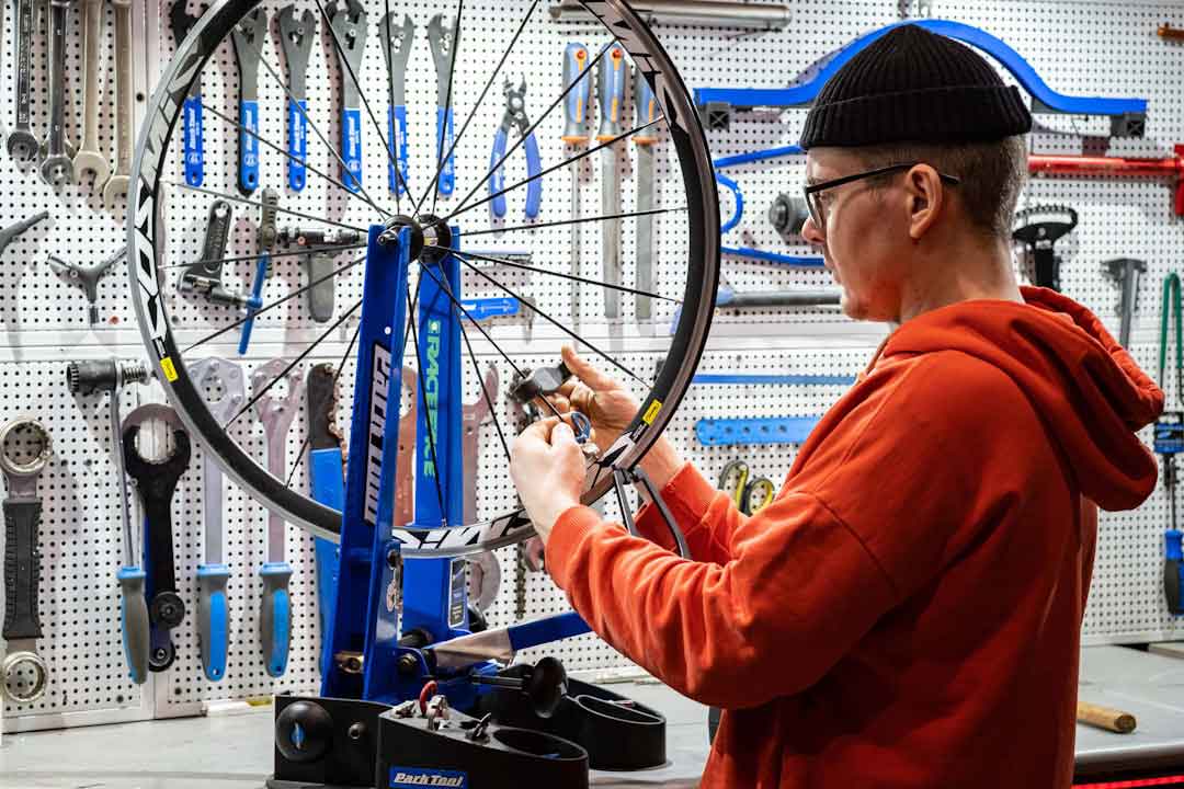 Cyclist cleaning and maintaining a fixie bike frame
